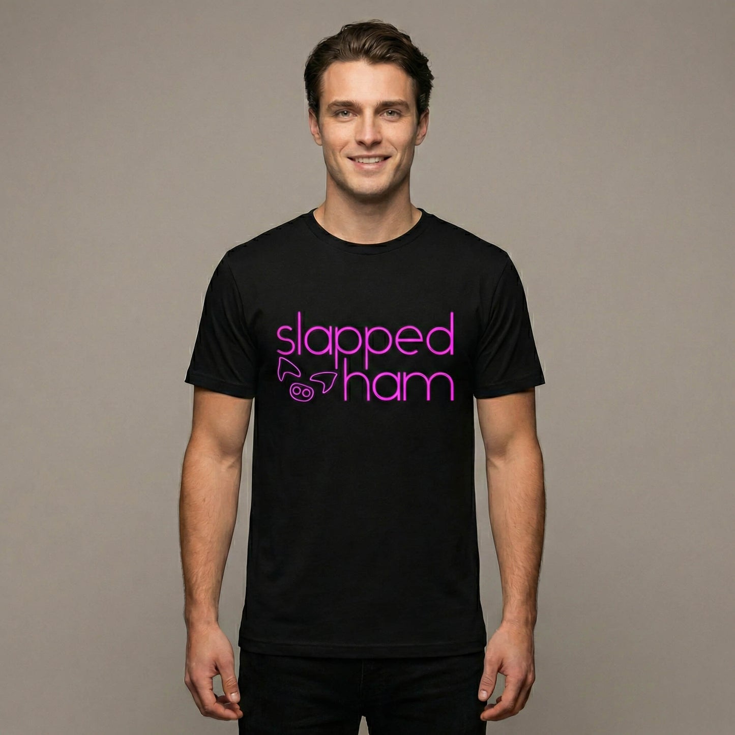 Man wearing a black t-shirt with 'slapped ham' text on a black background