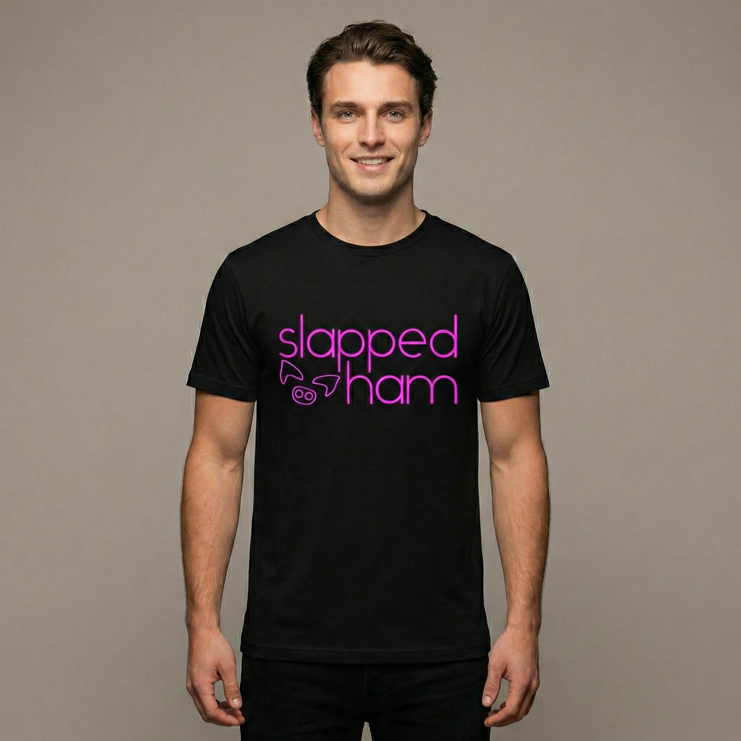 Man wearing a black t-shirt with 'slapped ham' text on a black background
