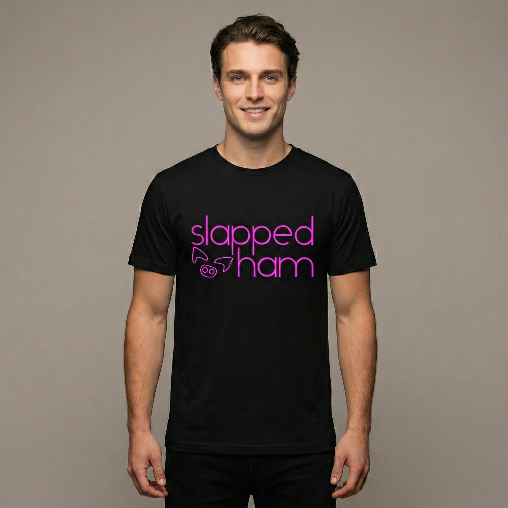 Man wearing a black t-shirt with 'slapped ham' text on a black background