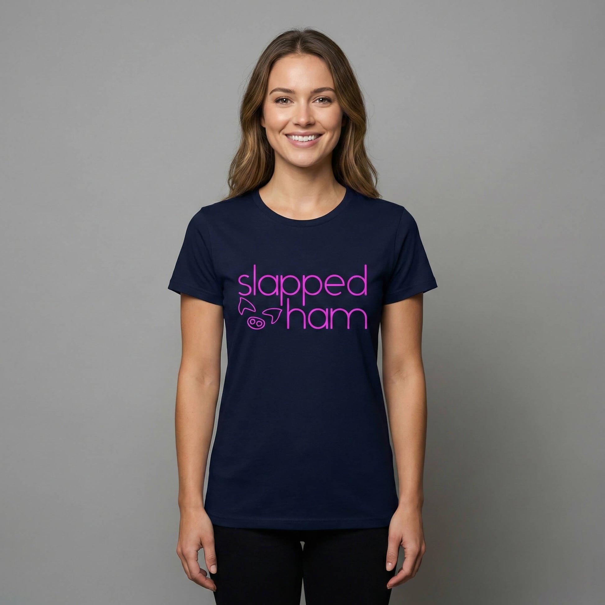 Woman wearing a navy blue t-shirt with 'slapped ham' text on a navy blue background