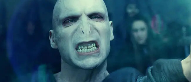 Voldermort growling, showing his teeth. Voldermort is one of the iconic movie villains that scared you silly.