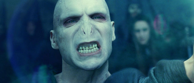 Voldermort growling, showing his teeth. Voldermort is one of the iconic movie villains that scared you silly.