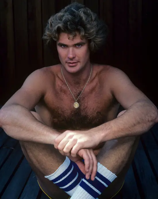 A young David Hasselhoff poses for a photo in just shorts and socks.