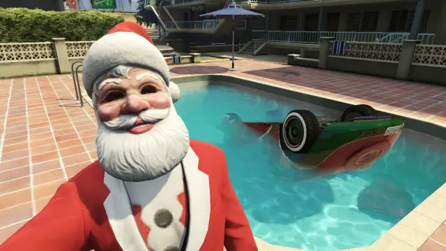 Man dressed as santa taking a selfie with a car in a pool on GTA V.