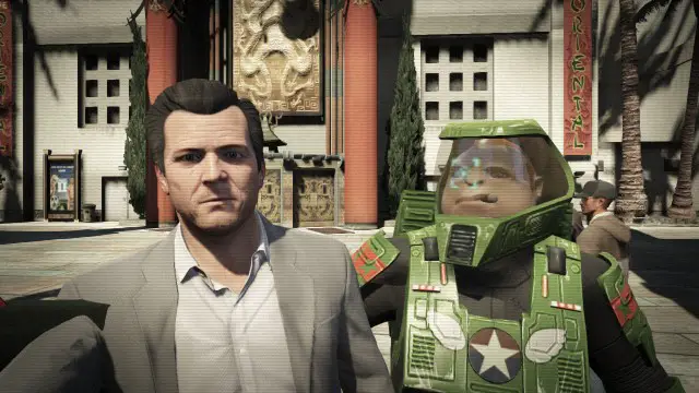 Michael taking a selfie with a man in a green space suit on GTA V.