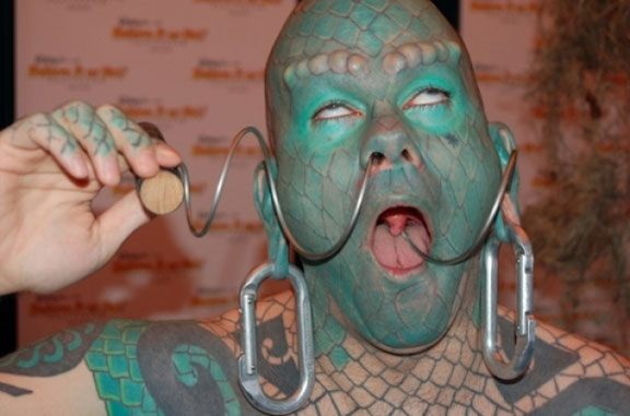 The Lizardman Erik Sprague with a corkscrew through his nose - 10 Most Insane Body Modifications You Just Have To See