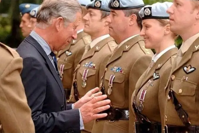 A photo of Prince Charles reaching for a female soldier - 10 Amazing Photos Taken At Just The Right Time
