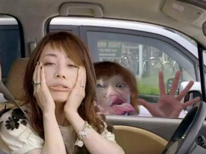 A girl in a car pulling a funny face while someone behind her presses their face against the car window - 10 Most Chilling Photobombs Ever Caught On Camera