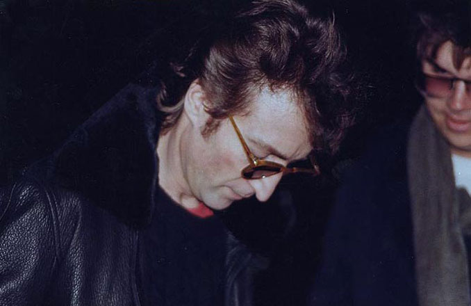 John Lennon signing an autograph for Mark David Chapman - 10 REAL Photos With Unsettling Backstories