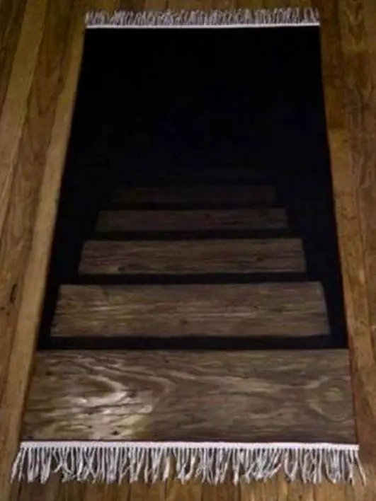 A door mat designed to look like it is stairs leading to the basement.