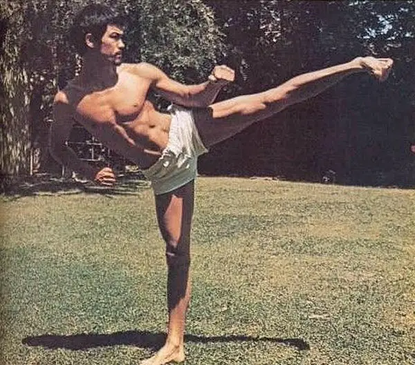 Bruce Lee performing a side kick.