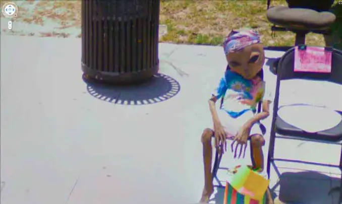 An alien sitting on a chair seen on Google Maps.