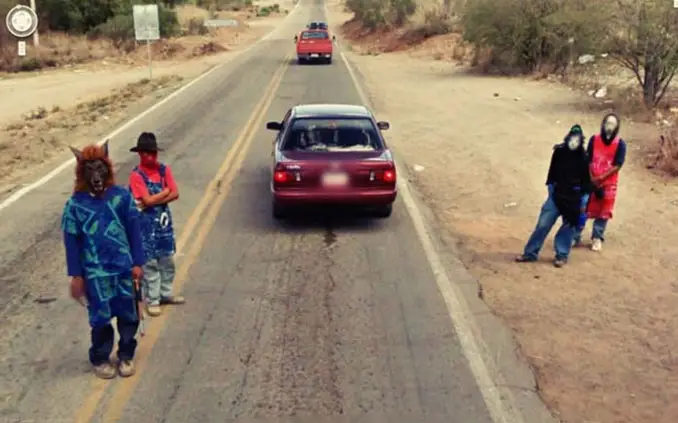 Men in masks standing on the road seen on Google Street View.