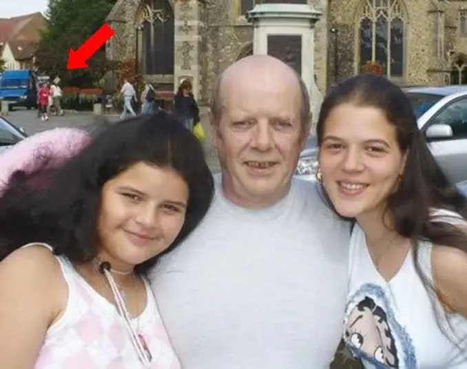 Michael Dick posing for a photo with his two daughters.