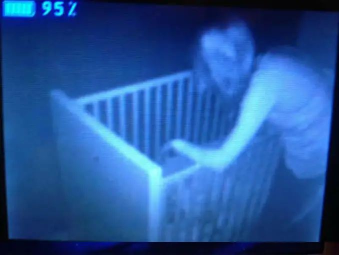 Scary woman leaning over crib seen on baby monitor - 10 Terrifying Things Caught on Baby Monitors