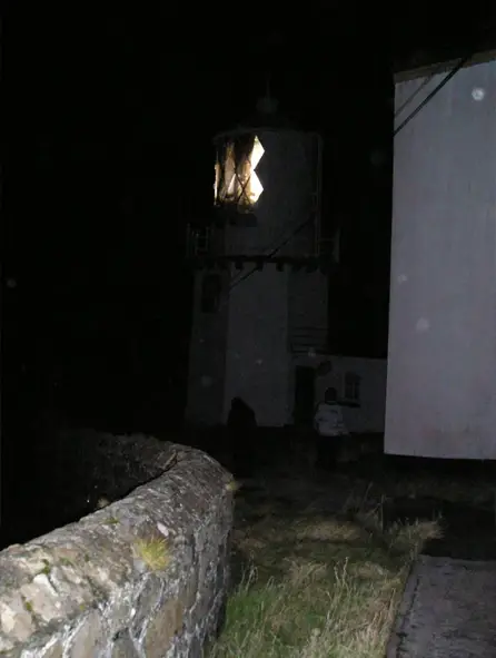 Creepy monk appears in photo taken at the Blackhead Lighthouse in County Antrim, Northern Ireland - These Creepy Photos Cannot be Explained