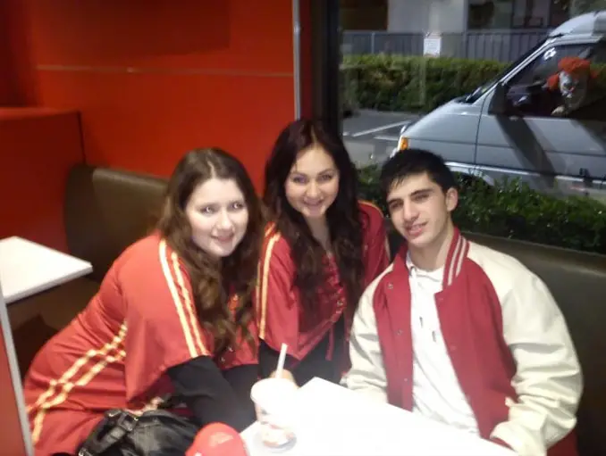 A creepy clown photobombs group of teens