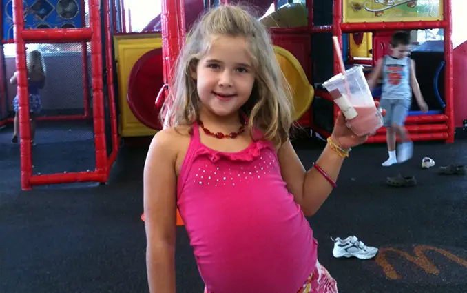 Photo of Annabel Beam holding milkshake at playground. Beam claims she's been to heaven.