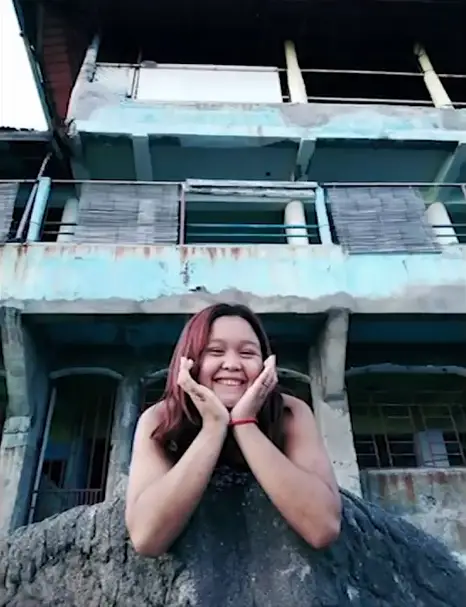 Photo of a girl smiling with a creepy face above her.