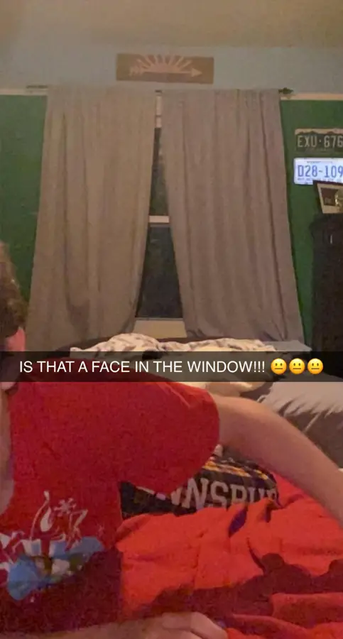 Photo of a creepy face staring through a window.